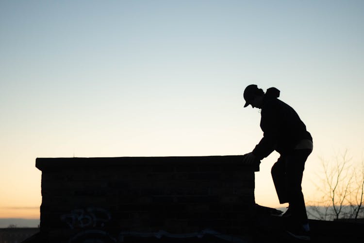 Silhouette Of Man By Chimney