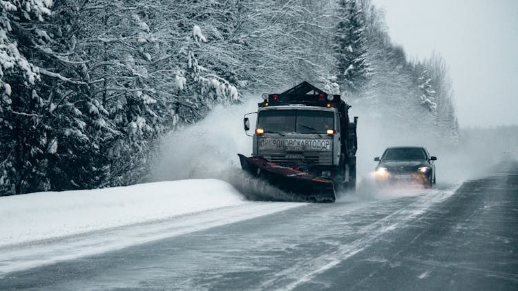 A Winter Service Vehicle Clearing The Road Of Snow