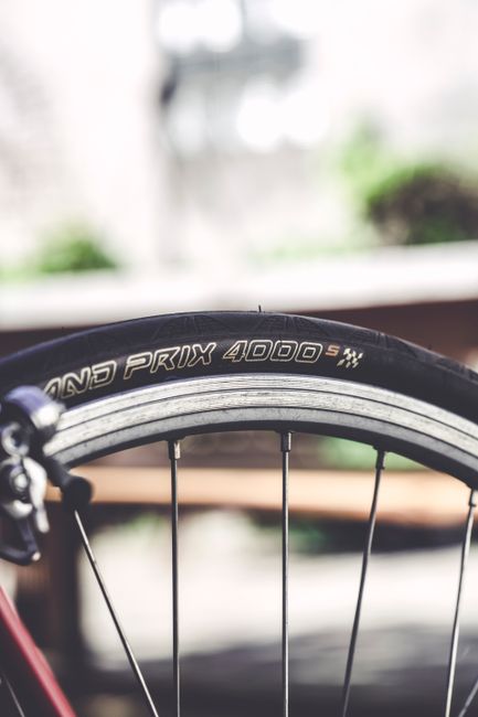 Detailed view of a racing bicycle tire with focus on the Grand Prix 4000 brand.