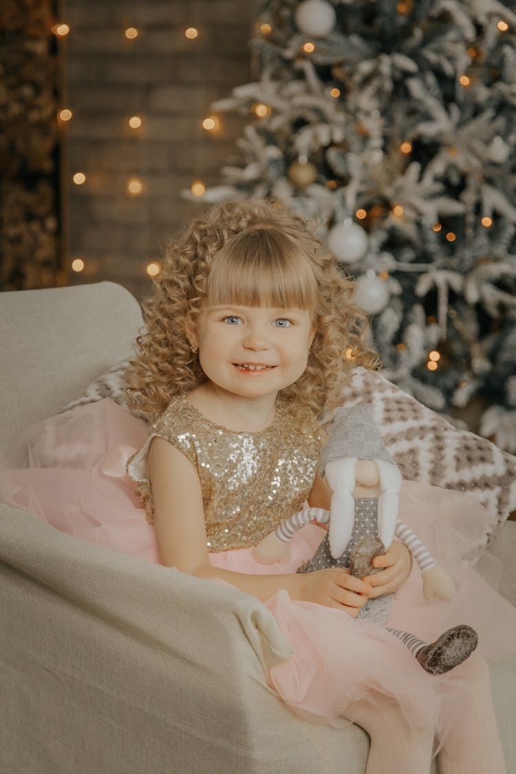 Smiling Girl With Toy During Christmas