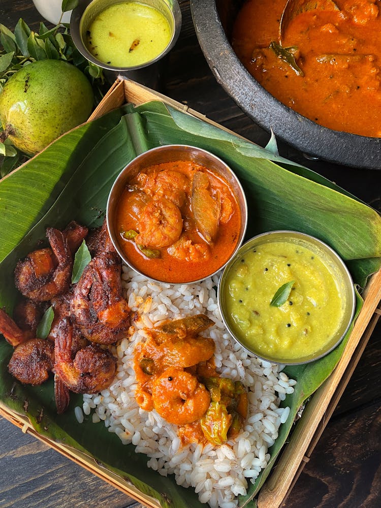 Curry With Rice And Seafood Served On Banana Leaf