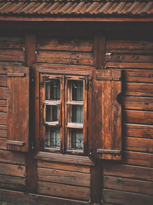 Free Rustic wooden cabin window with open shutters, captured in a vertical shot. Stock Photo
