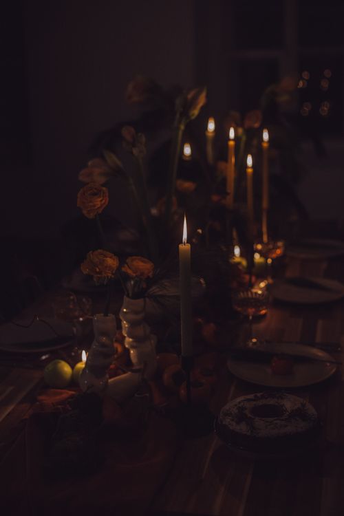 Free Elegant table setting with candles and flowers, creating a warm, romantic ambiance. Stock Photo
