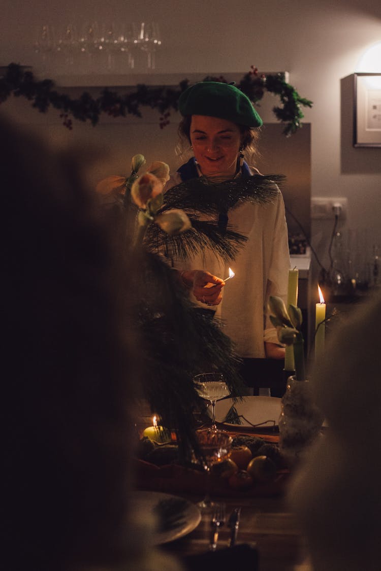 Woman Lighting The Candles On A Table 