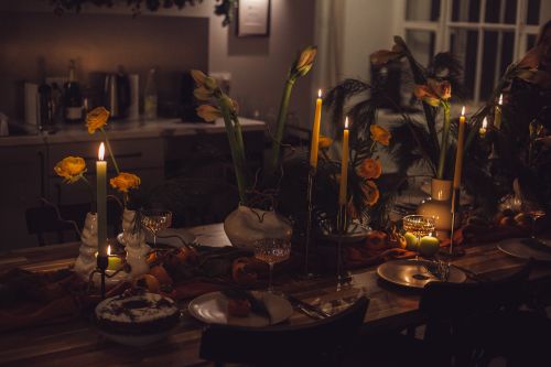 Free Inviting candlelit dinner table with elegant decor and warm atmosphere. Stock Photo