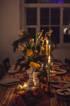 A beautifully decorated dining table with candles and flowers, perfect for a cozy evening.