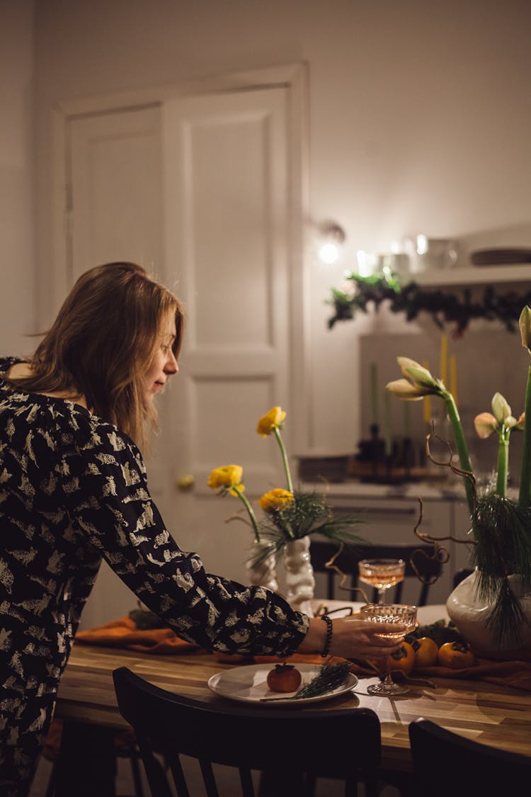 Woman Putting Glass On Table