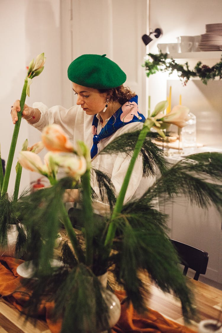 Woman Putting Plants On Table