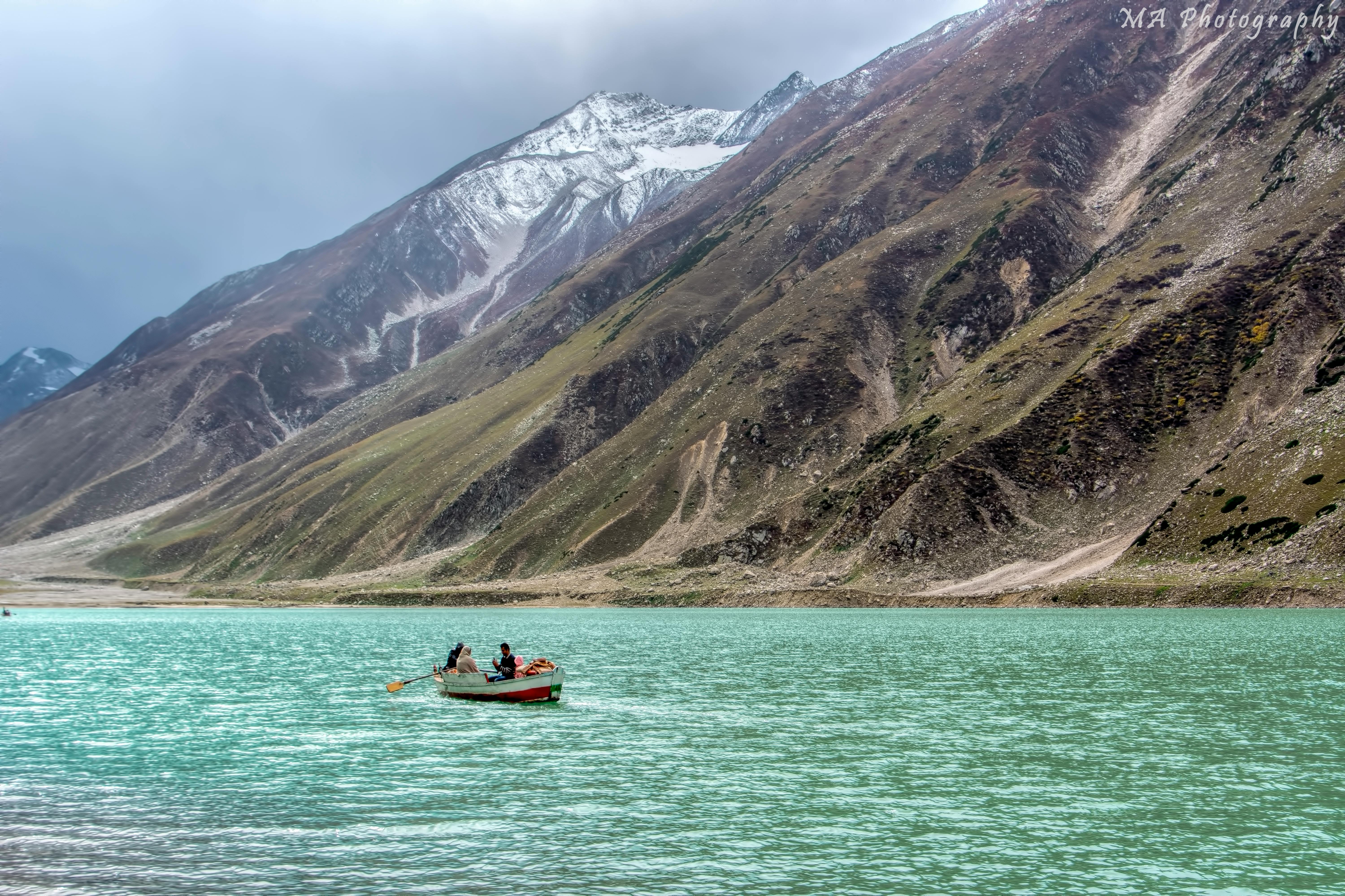 Free People Riding a Boat in a Lake Stock Photo