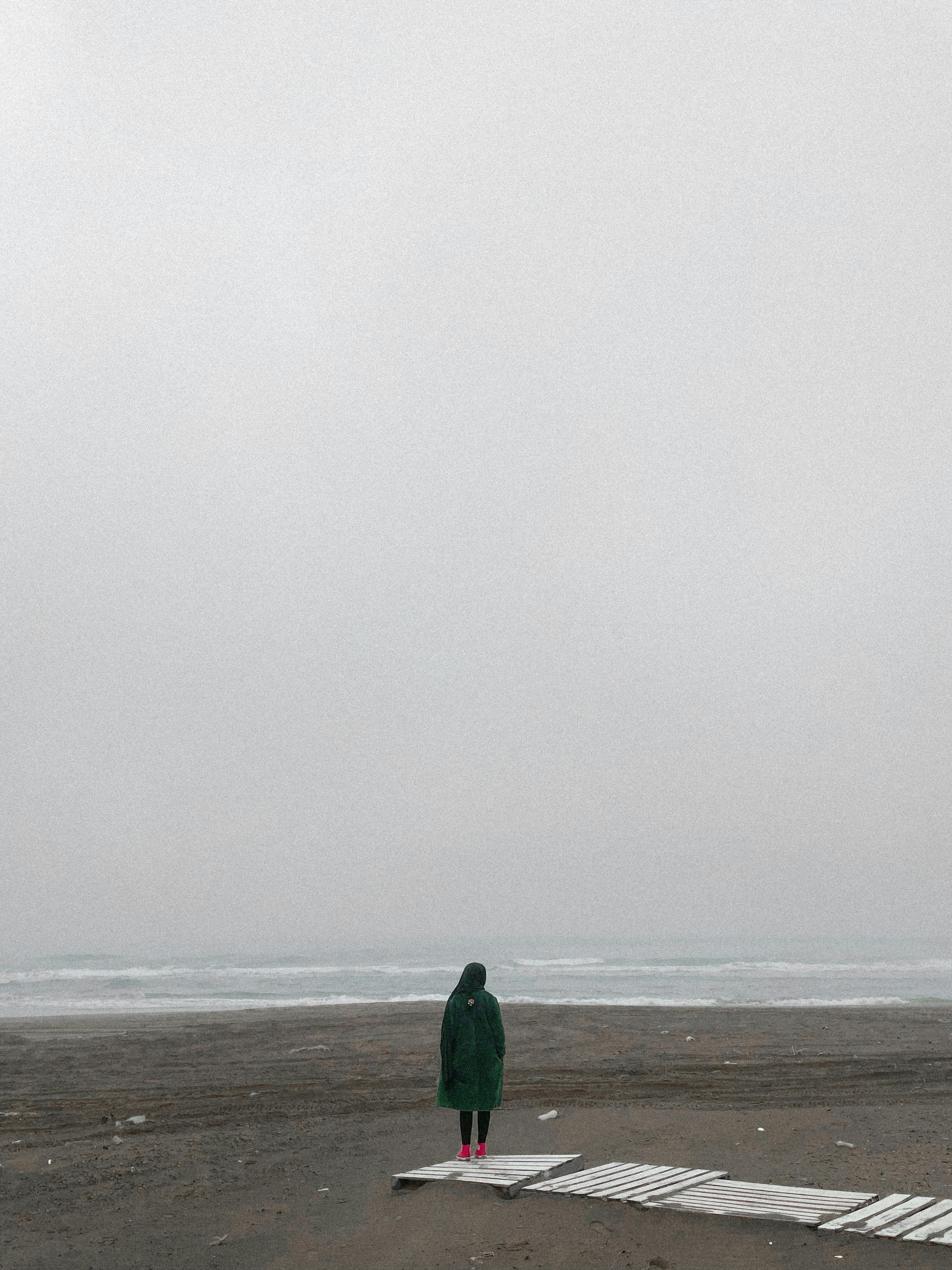 Man Standing In Shorts On Sea Beach In Overcast Day Stock Photo, Picture  and Royalty Free Image. Image 42731732.