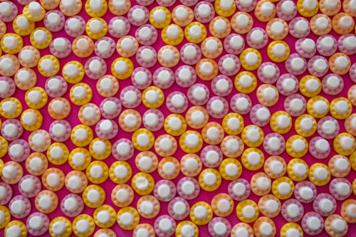 Colorful Candies on Pink Background 