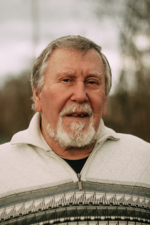 Man in Gray Zip Up Jacket with White Beard and Mustache