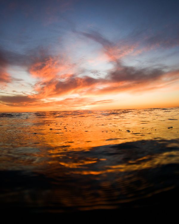 A peaceful sunset over calm ocean water