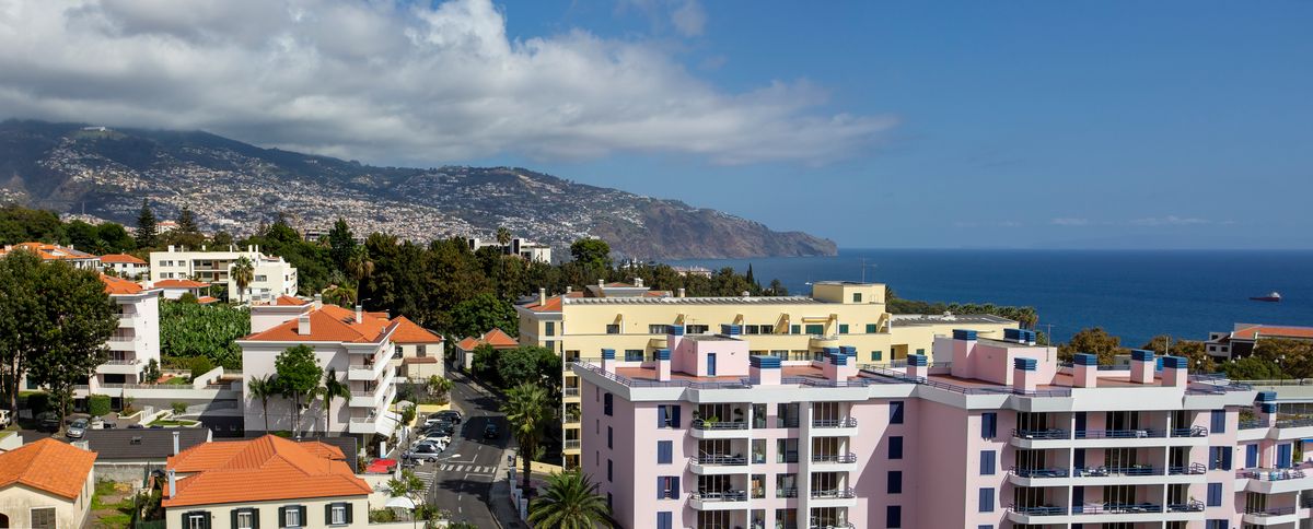 An aerial view of city buildings near the ocean in Funchal