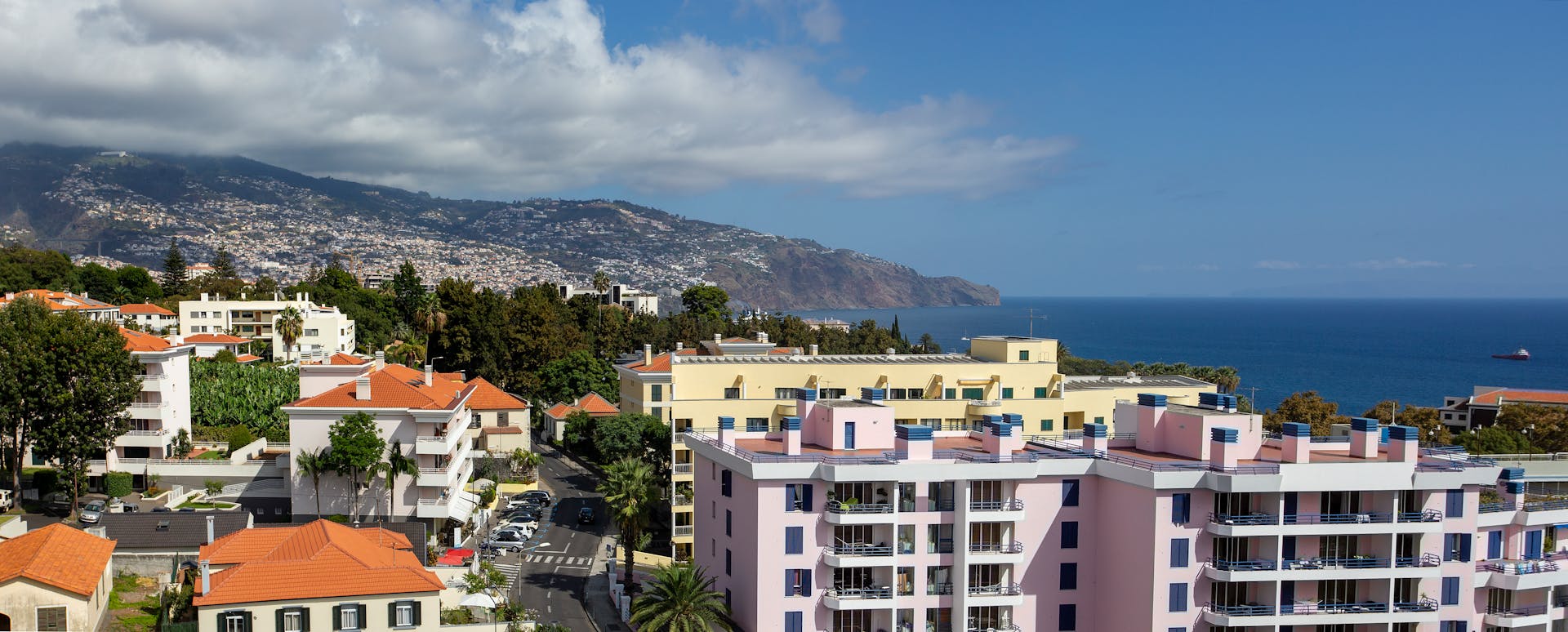 Aerial view of Funchal, Madeira showcasing vibrant coastal architecture with ocean backdrop.