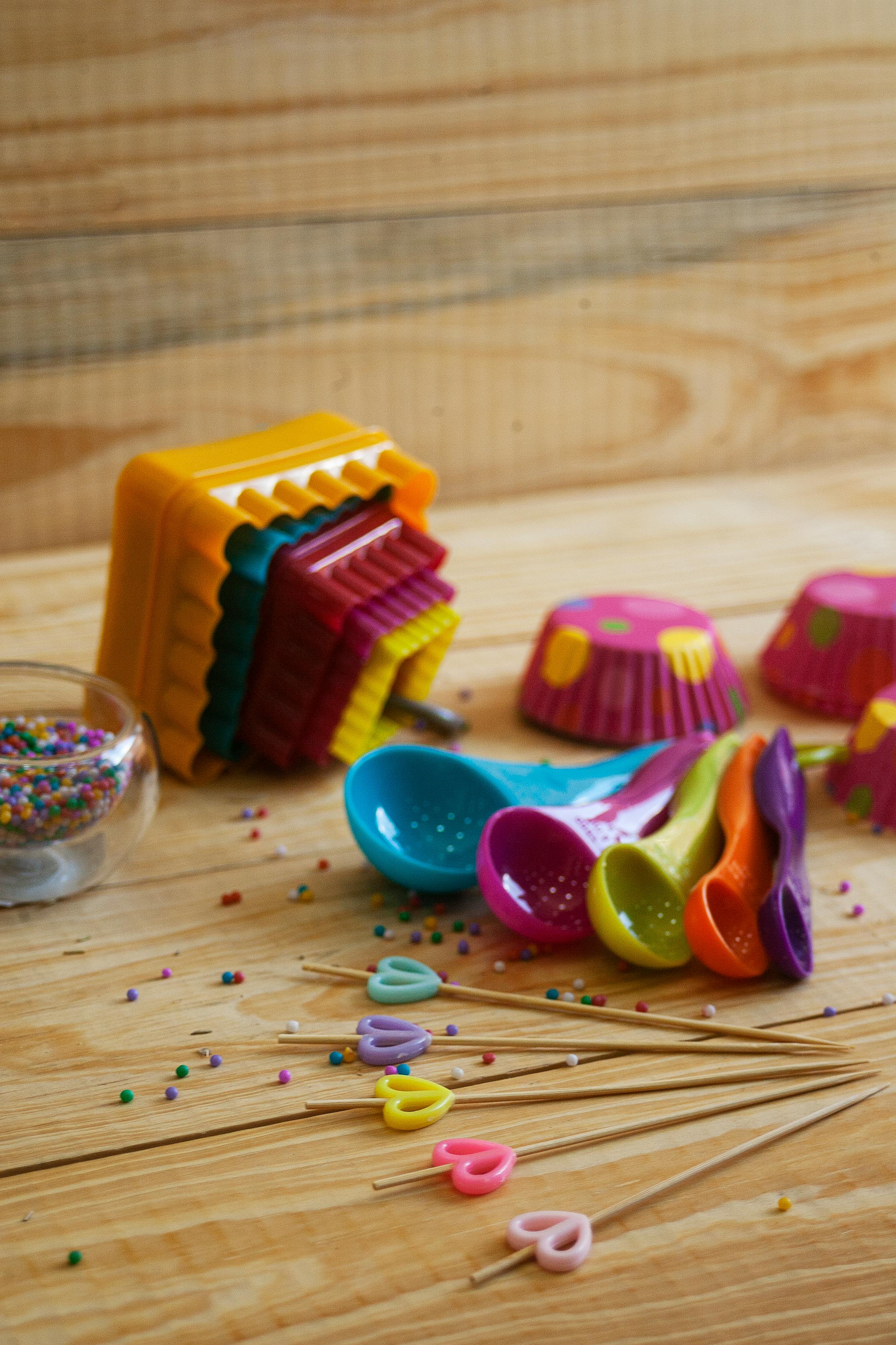 yellow pink and green candies on brown wooden table