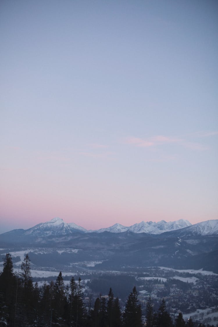 Aerial View Of Snowcapped Mountains At Sunset 