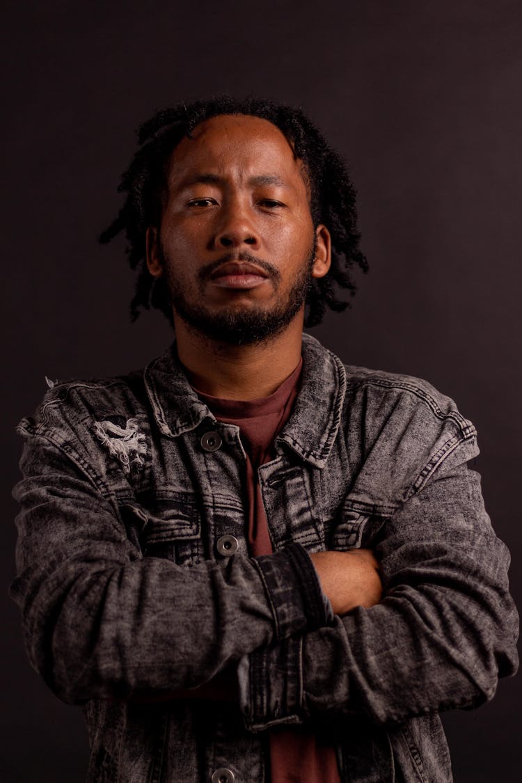 Portrait Of Serious Man On Black Studio Background