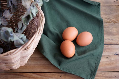 Free 2 Organic Eggs on Green Textile Stock Photo