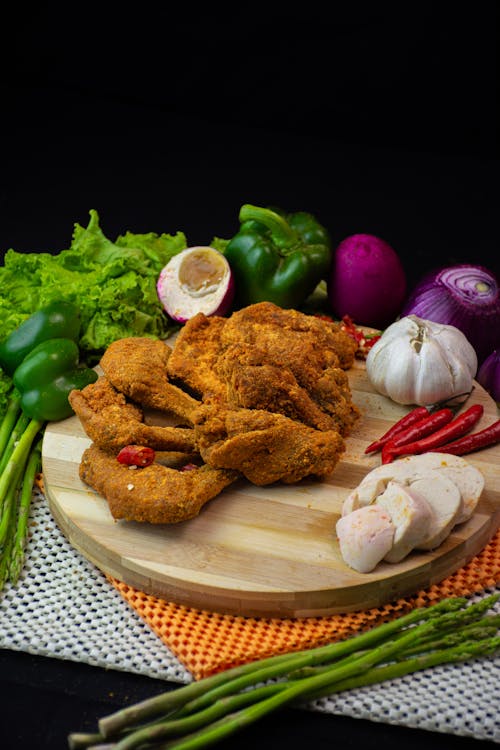 Wooden Cutting Board with Chicken and Raw Vegetables