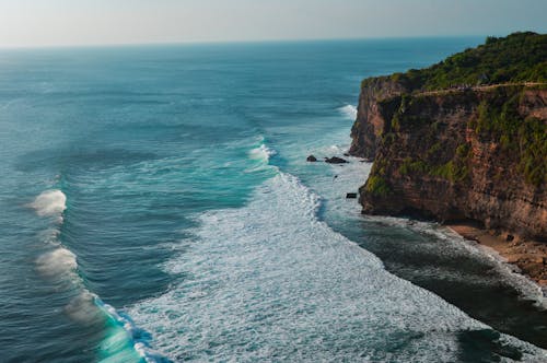Free Waves Crashing against Coastal Cliff Stock Photo