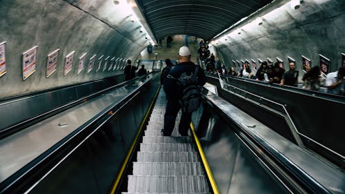 Man in Black Leather Jacket on Escalator