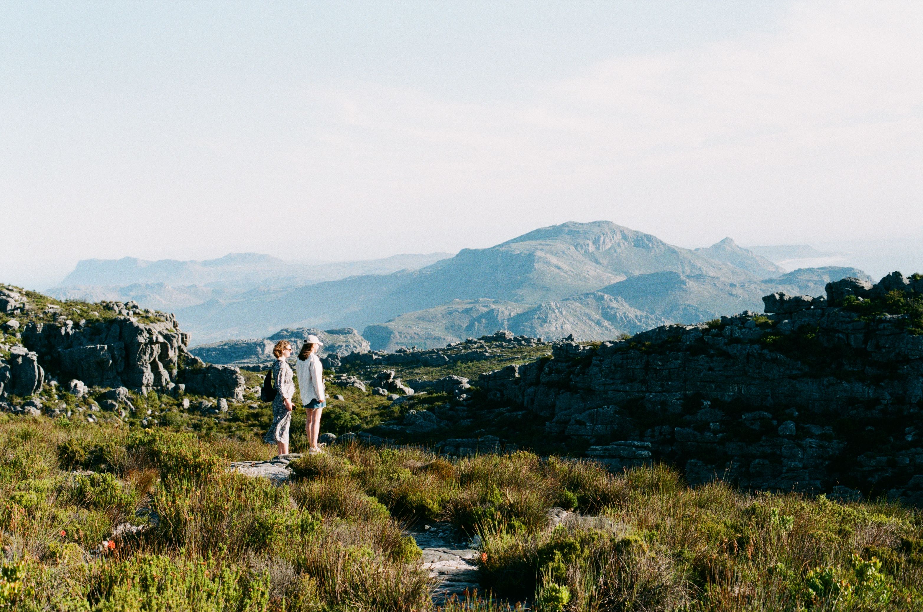 Unbeatable 1 Day Whale Watching at Yzerfontein Review: South Africa's Most Intimate Humpback Encounter Review 2026 - Two women enjoy a scenic hike in the breathtaking landscape of Cape Town, South Africa.