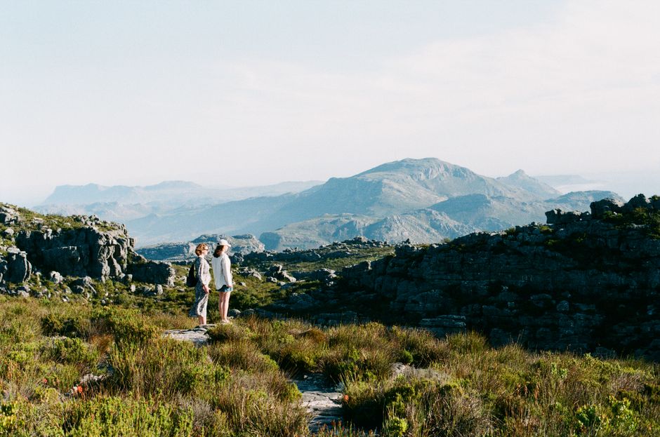 Unbeatable 1 Day Whale Watching at Yzerfontein Review: South Africa's Most Intimate Humpback Encounter Review 2026 - Two women enjoy a scenic hike in the breathtaking landscape of Cape Town, South Africa.