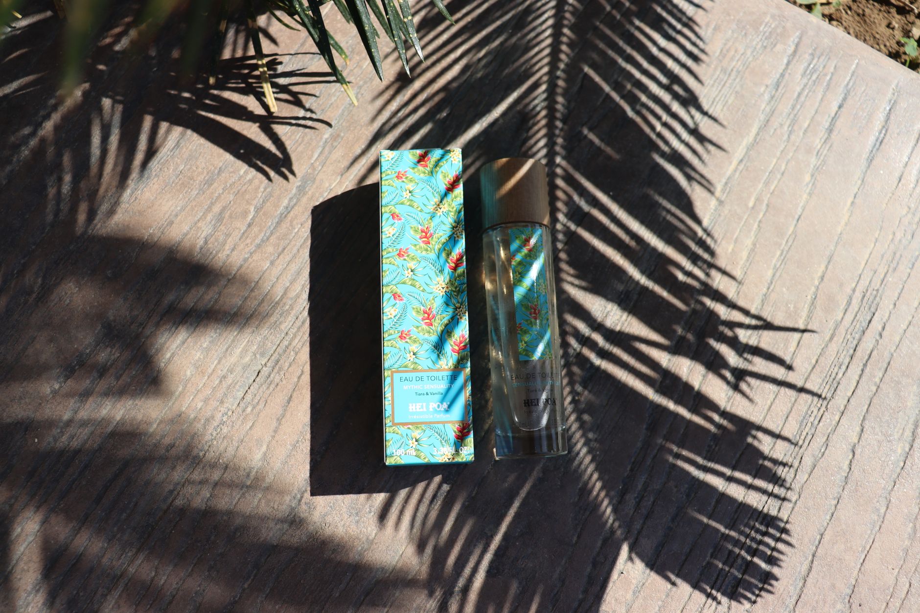 Elegant perfume bottle with tropical design on a wooden surface to inspire scent layering