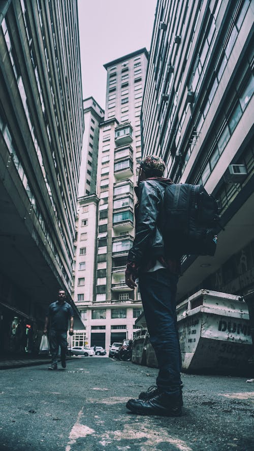Man Standing in Between Buildings