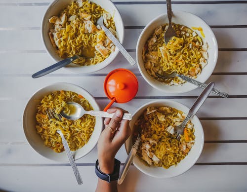 Close-Up Shot of a Person Getting Noodles