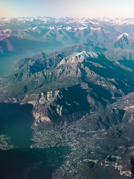 Stunning aerial view capturing the vast expanse of a mountainous landscape with peaks and valleys.