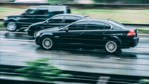 Two dark cars in motion on a wet highway — photo by Kaique Rocha on Pexels