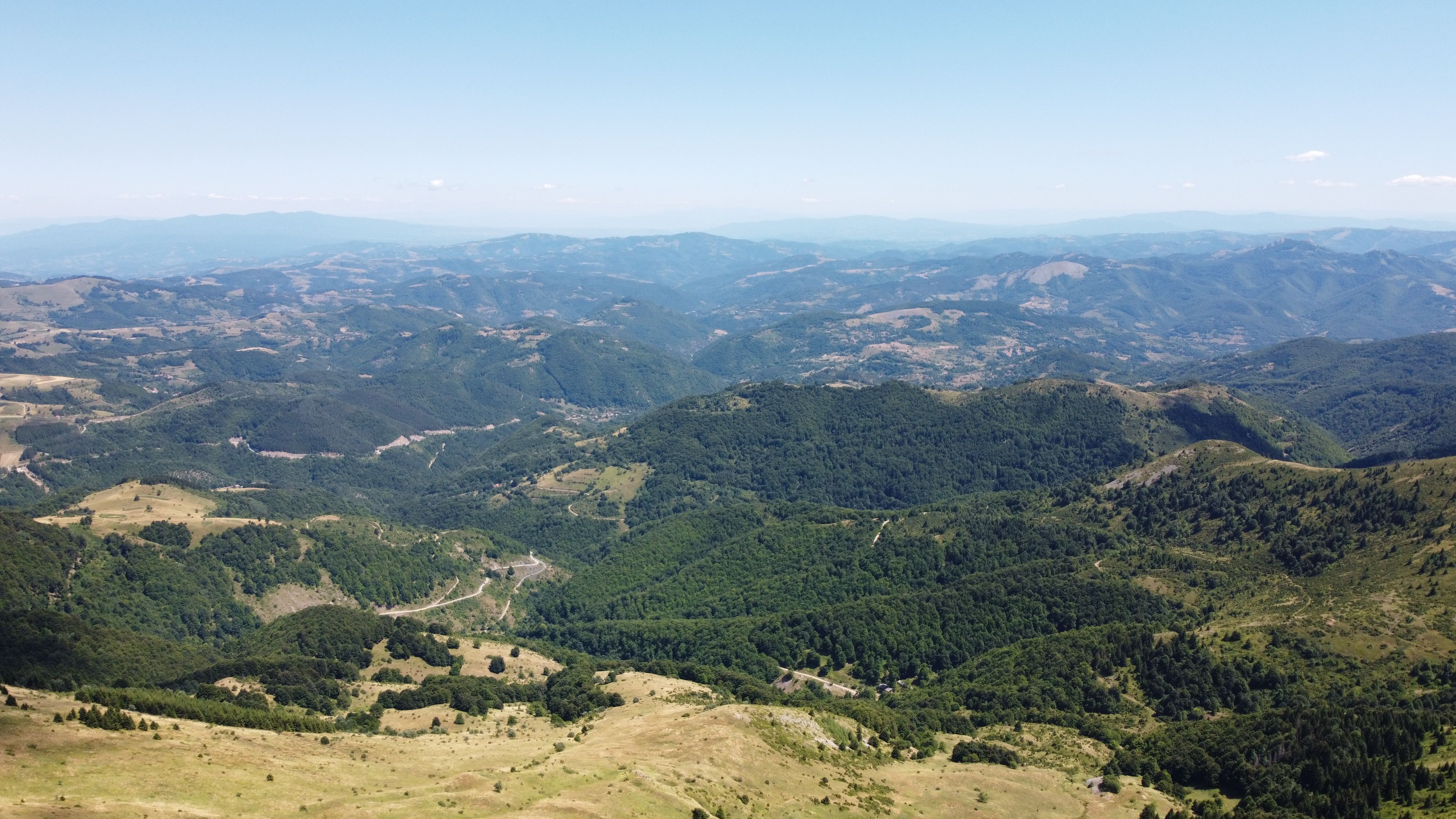 A breathtaking aerial shot capturing the expanse of green hills and mountains in Serbia.