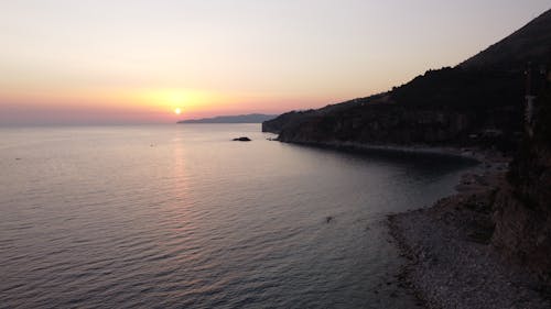 Безкоштовне стокове фото на тему «берег моря, гора, Захід сонця» стокове фото