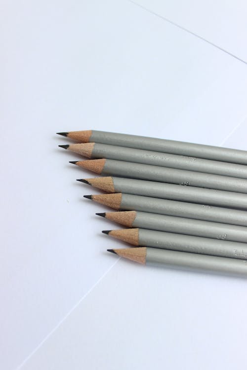 Close-Up Shot of Pencils on a White Surface