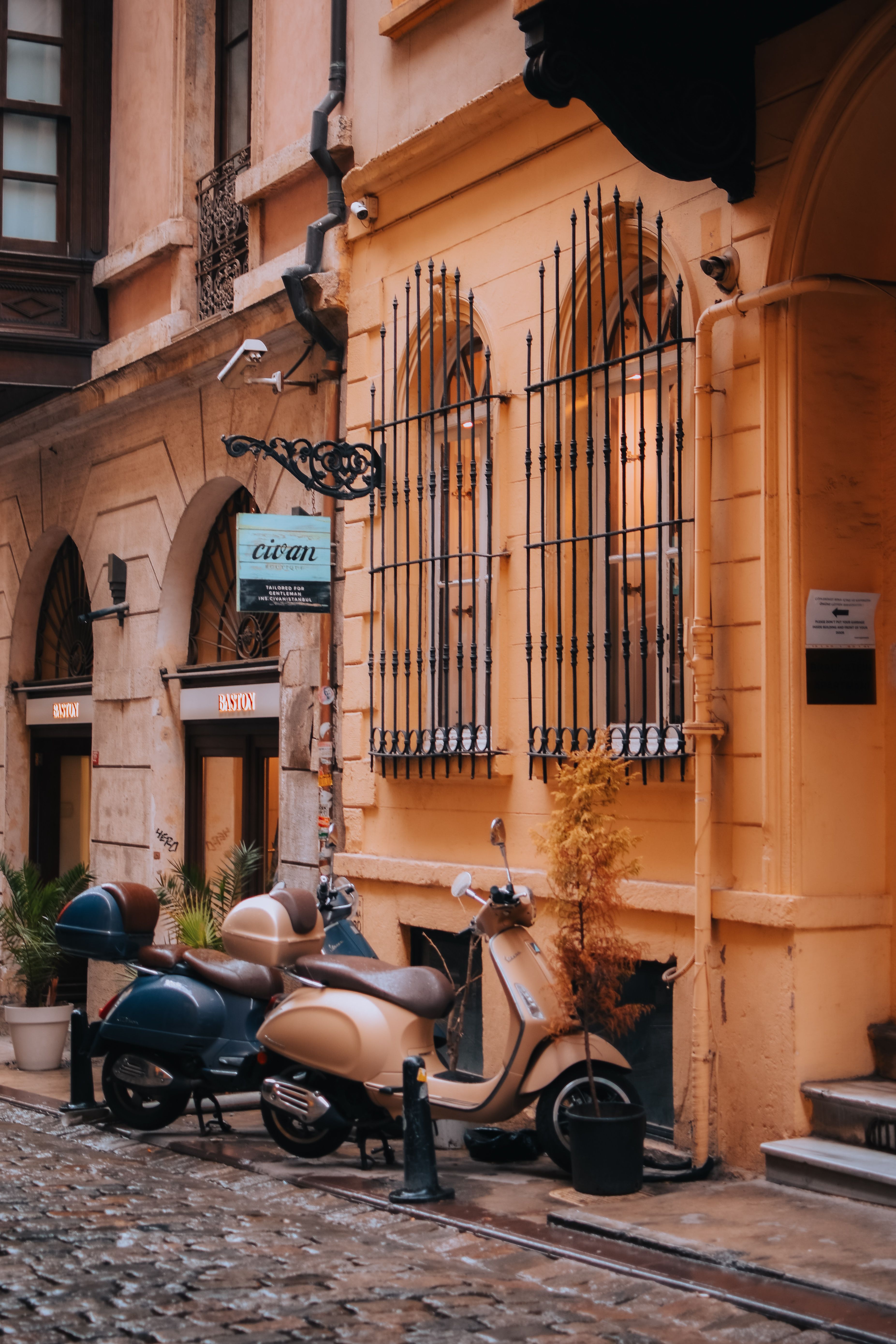 Beautiful street scene in Istanbul featuring vintage scooters and ornate architecture.