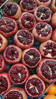Colorful display of fresh pomegranates cut open at a market in İstanbul, Turkey.