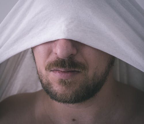 Free Close-Up Shot of a Bearded Man Covering His Eyes Stock Photo