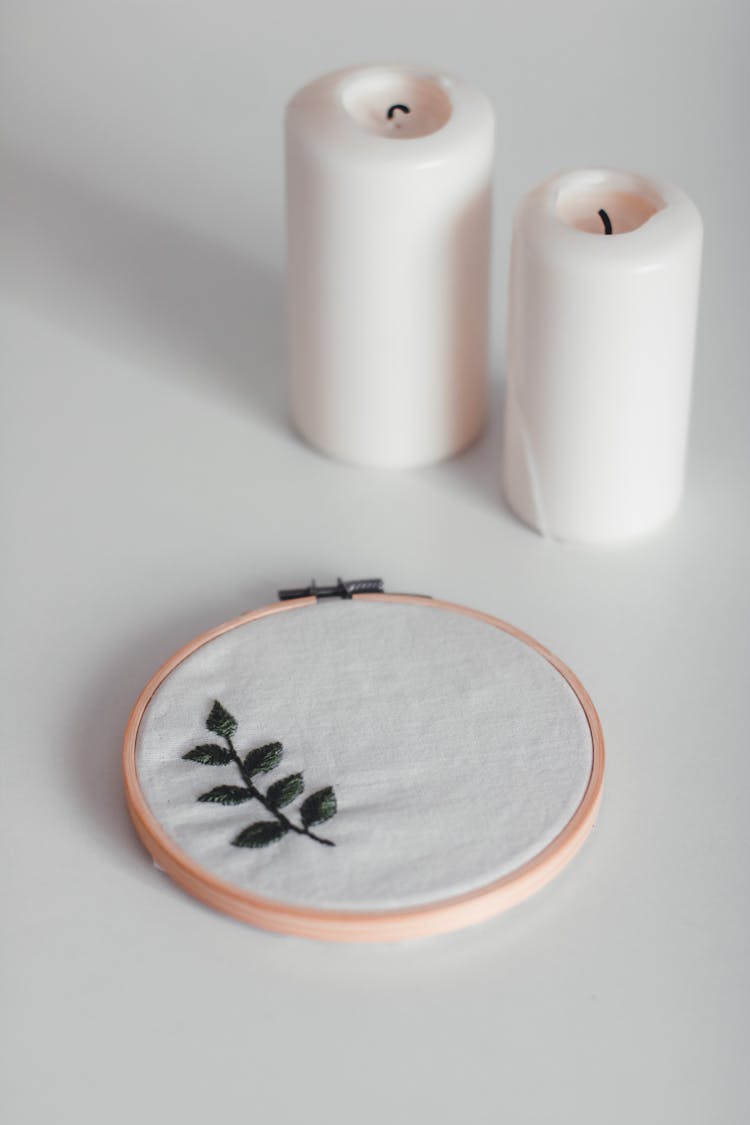 Embroidered Leaves On A Cloth And Candles 