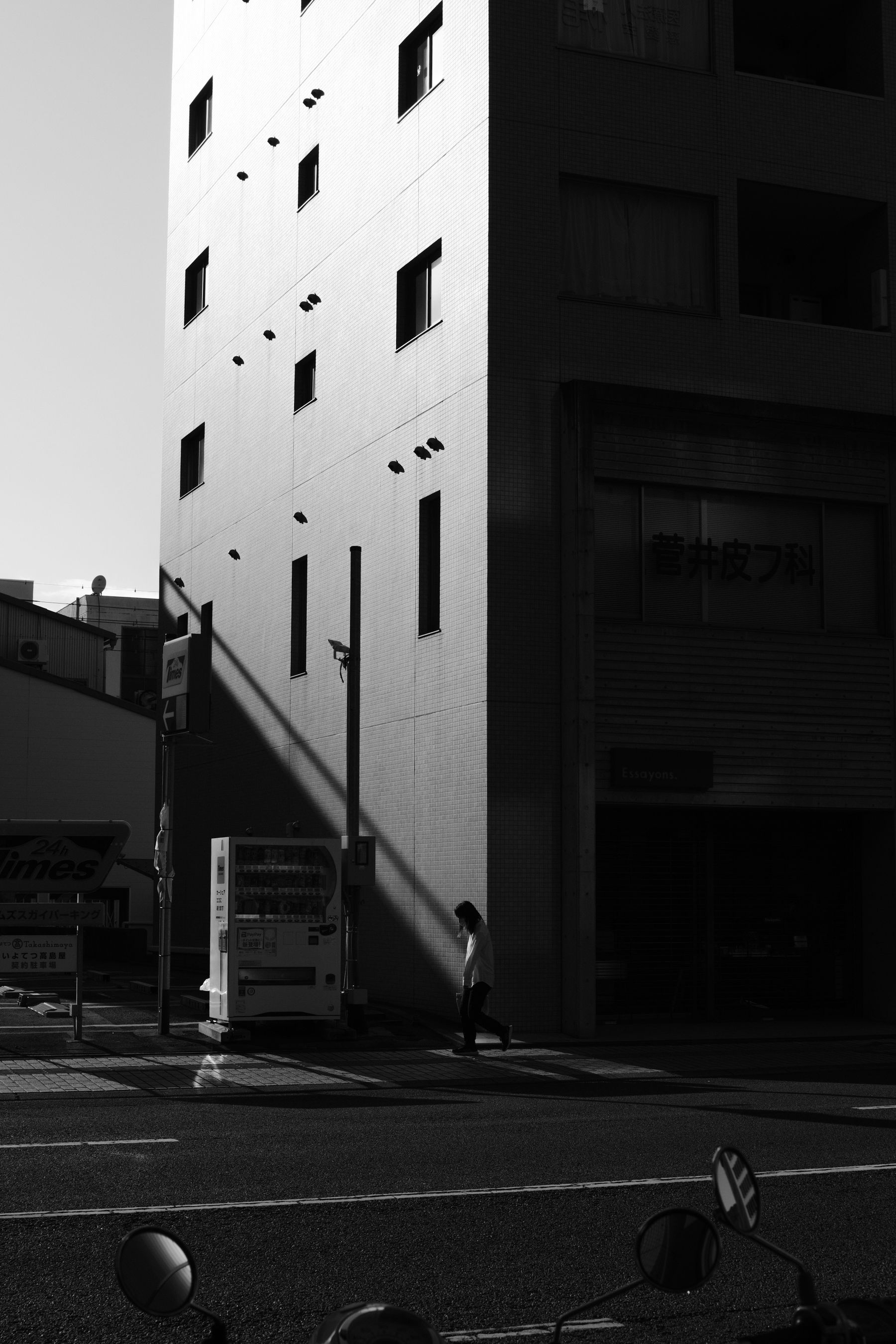 Black and white street scene with a vending machine in Japan