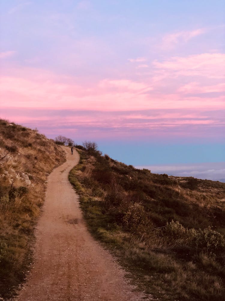 Person Walking Hilly Path 