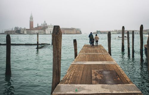 Free A wooden pier in Venice overlooking the iconic San Giorgio Maggiore across the water. Stock Photo