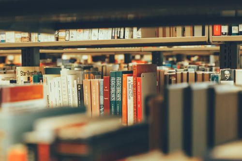 Free Bookshelves filled with diverse books capture a cozy library atmosphere indoors. Stock Photo