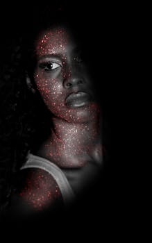 Creative portrait of a woman with sparkling glitter effect enhancing facial features.