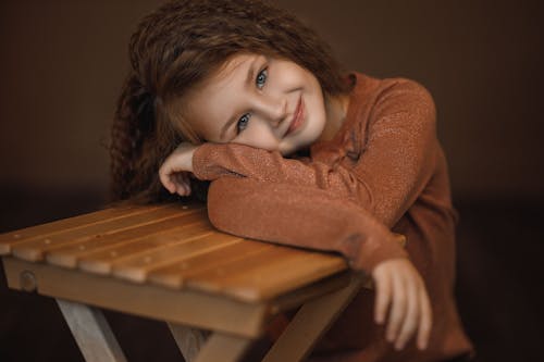 Free Pretty Girl Leaning on a Chair Stock Photo