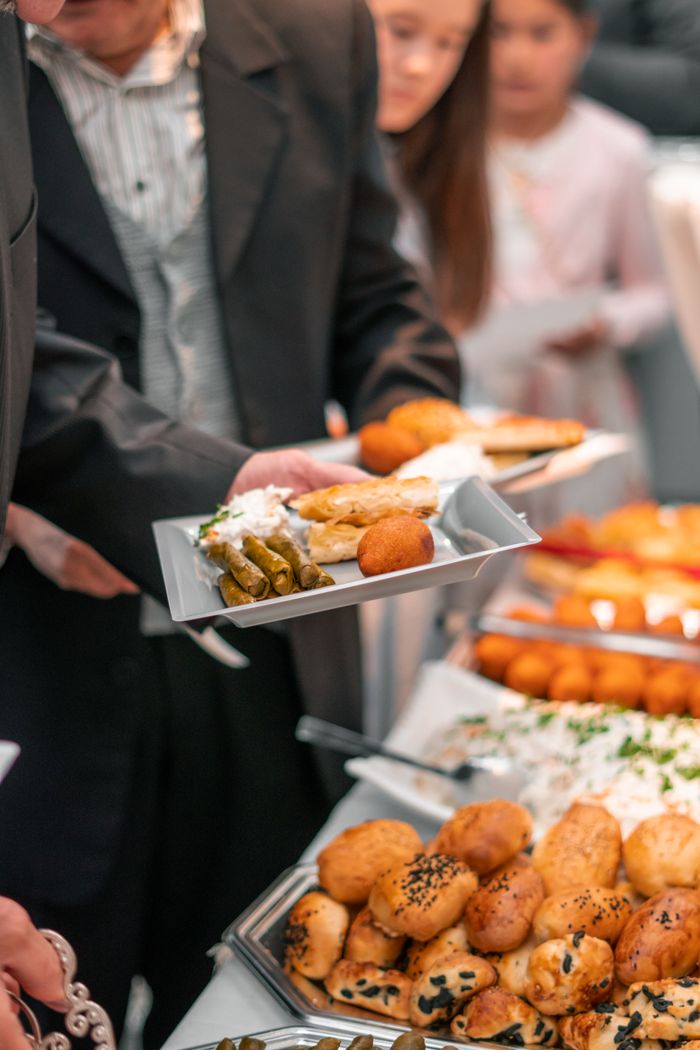 Guests taking food from a corporate event buffet