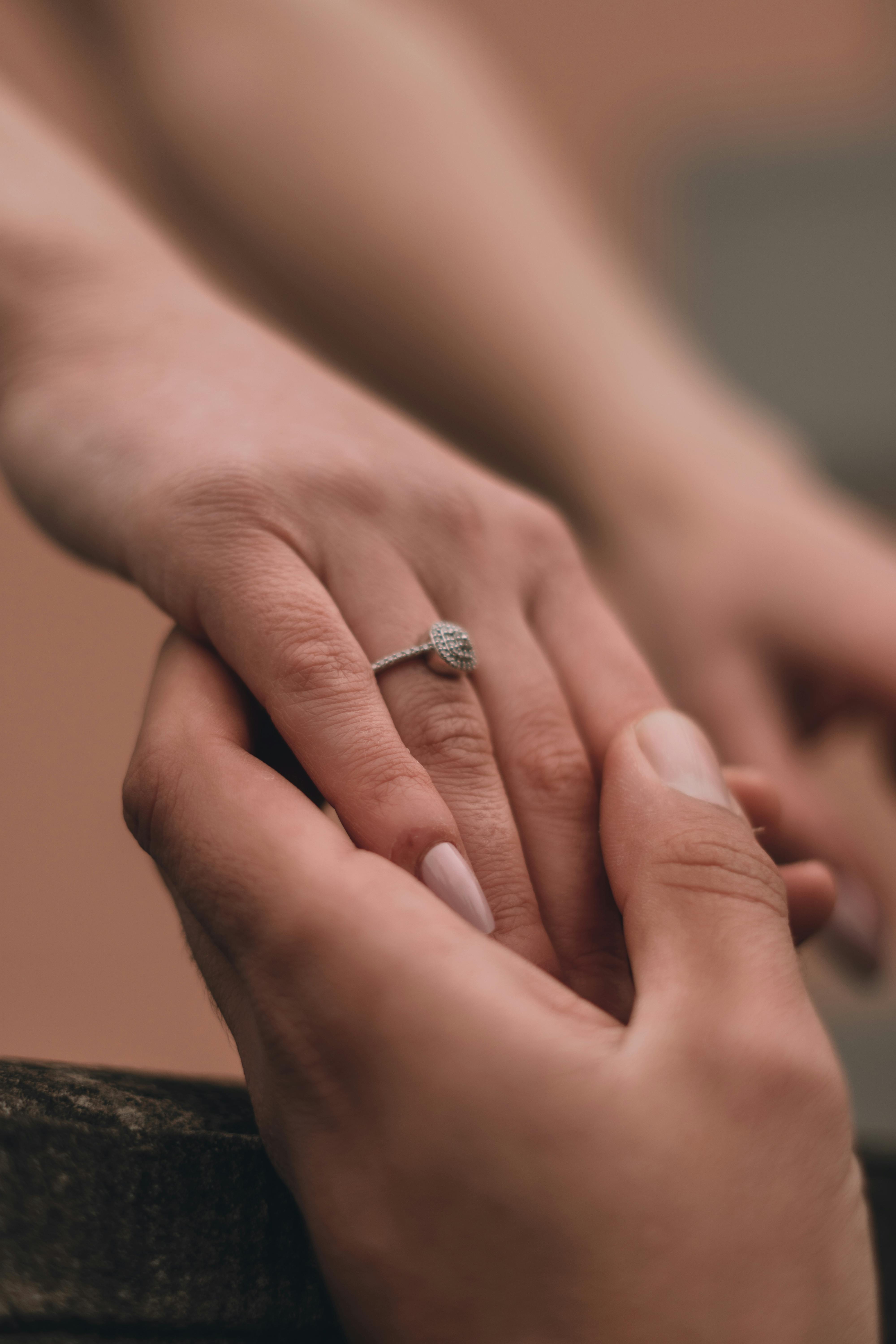Crop man and woman hands with engagement rings · Free Stock Photo