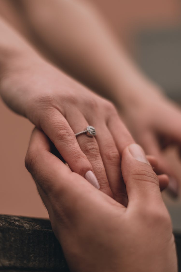 Man Holding Woman Hand With Engagement Ring