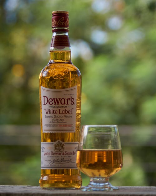 Close-Up Shot of a Bottle and Glass of Liquor 